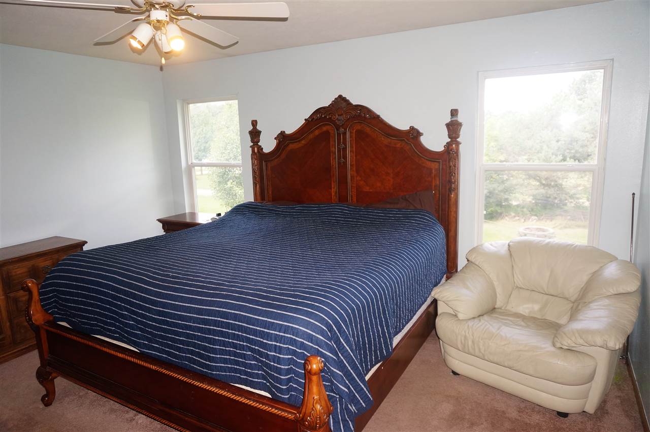 304 Rochester Road Northeast Poplar Grove, IL 61065 - Photo 13 of 23 a bedroom with a bed and a couch