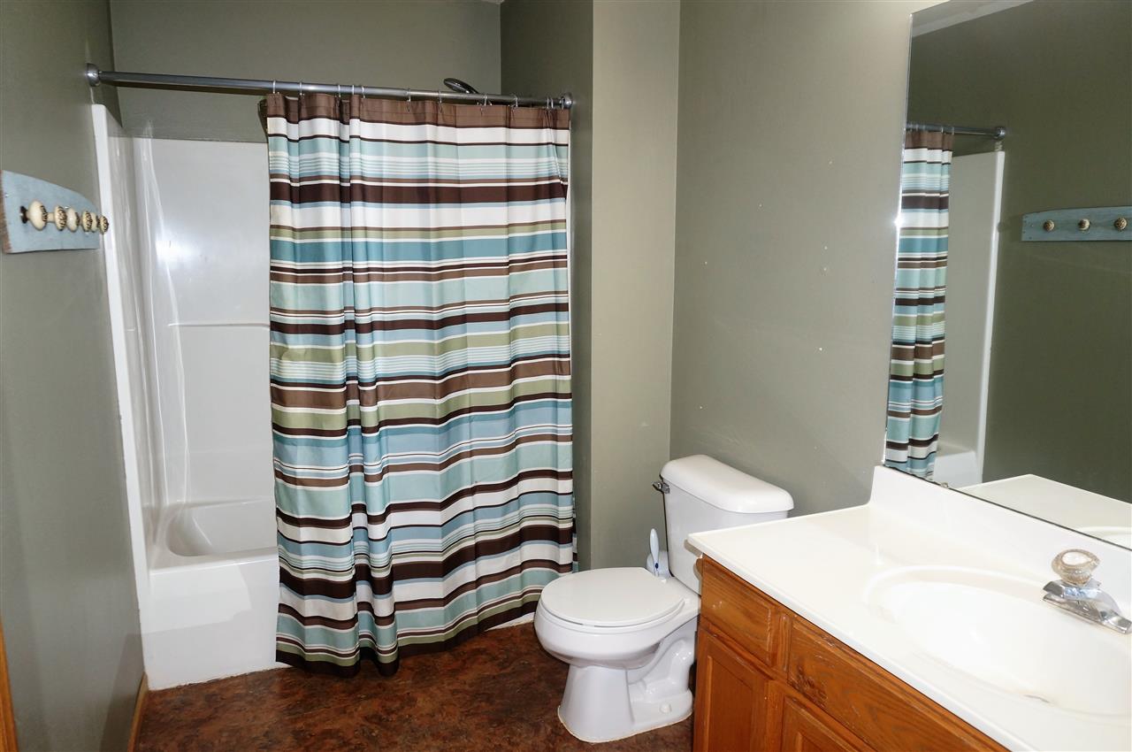 304 Rochester Road Northeast Poplar Grove, IL 61065 - Photo 16 of 23 a bathroom with a sink a toilet and shower
