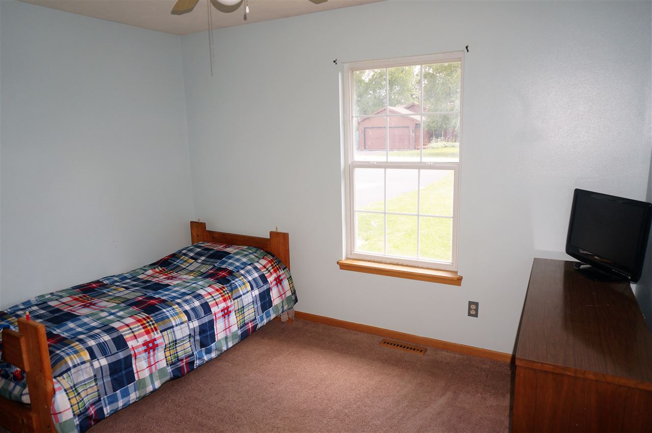304 Rochester Road Northeast Poplar Grove, IL 61065 - Photo 17 of 23 a bedroom with a bed and wooden floor