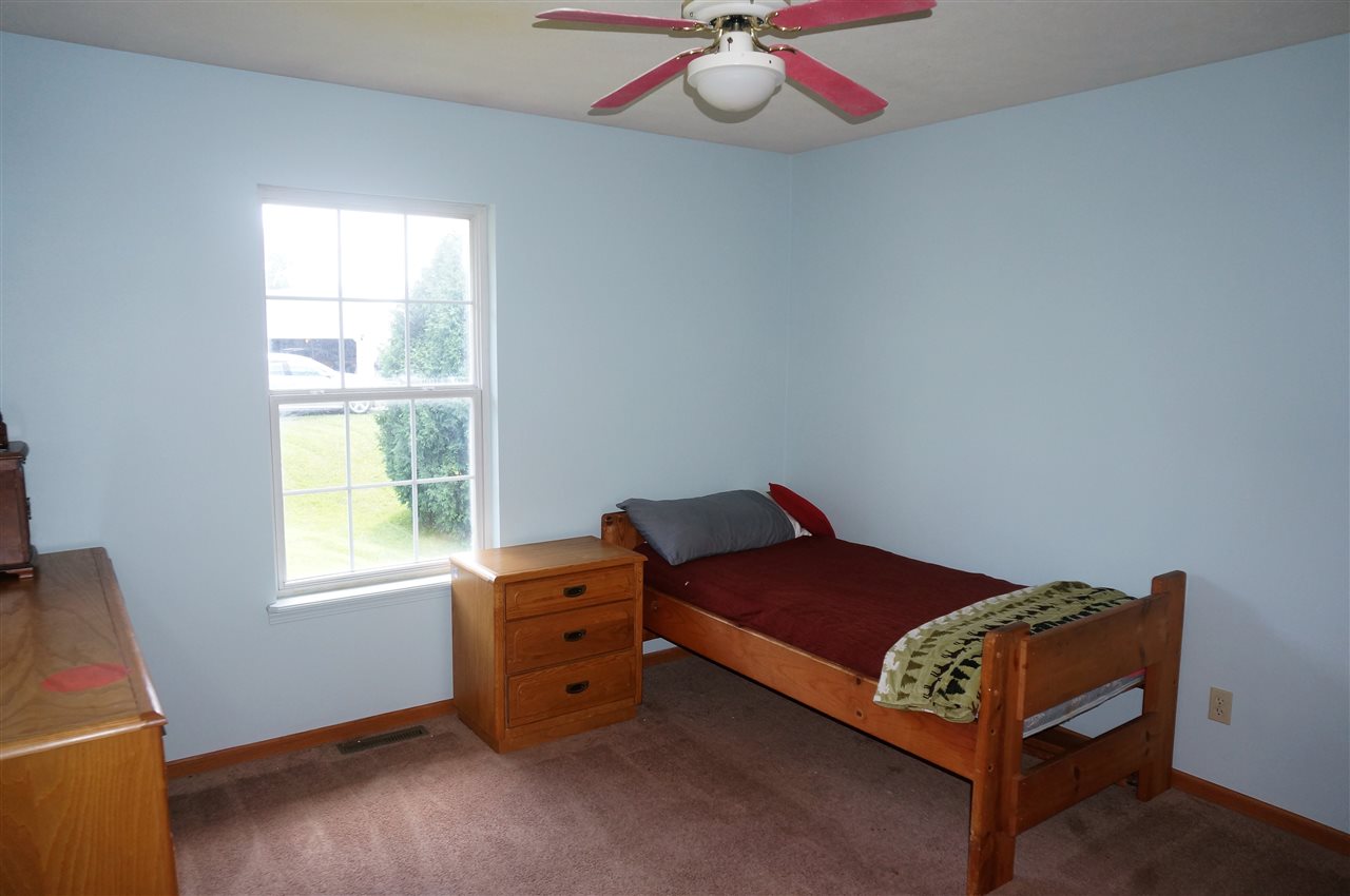 304 Rochester Road Northeast Poplar Grove, IL 61065 - Photo 18 of 23 a room with a bed and a window