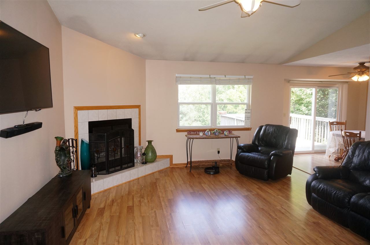 304 Rochester Road Northeast Poplar Grove, IL 61065 - Photo 4 of 23 a living room with furniture and a fireplace