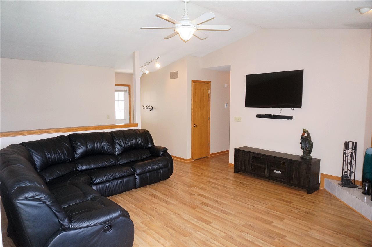 304 Rochester Road Northeast Poplar Grove, IL 61065 - Photo 6 of 23 a living room with furniture and a flat screen tv