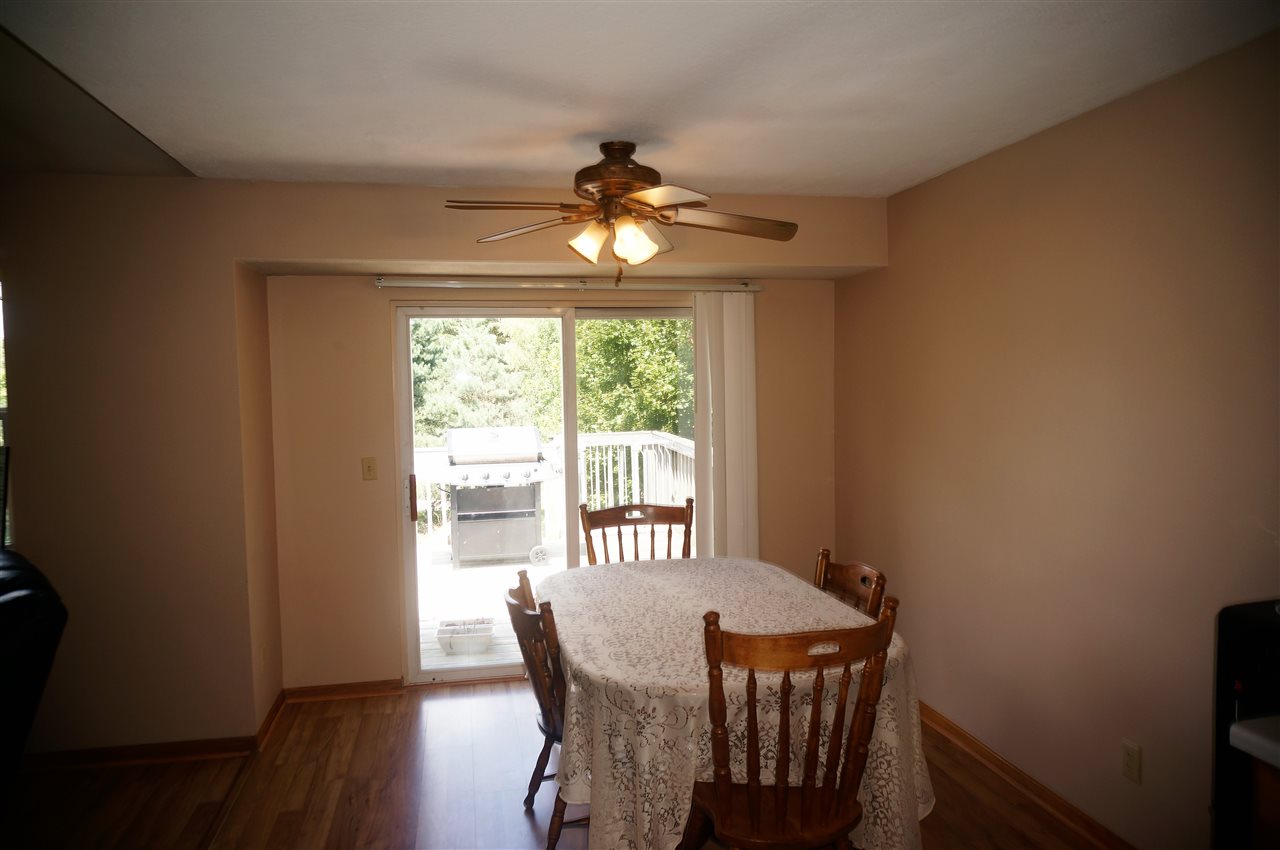 304 Rochester Road Northeast Poplar Grove, IL 61065 - Photo 9 of 23 a view of a dining room with furniture wooden floor and chandelier