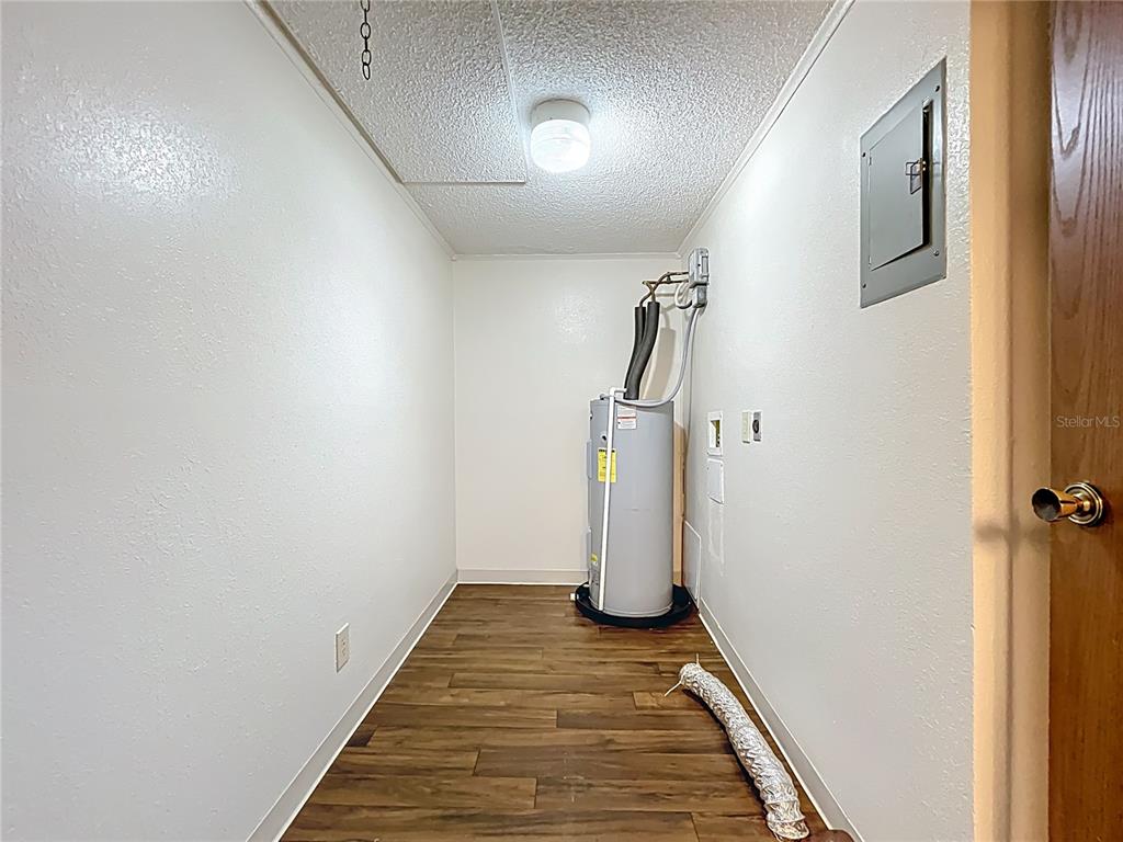 611 Mt Homer Road Eustis, FL 32726 - Photo 18 of 20 a view of a storage & utility room with wooden floor