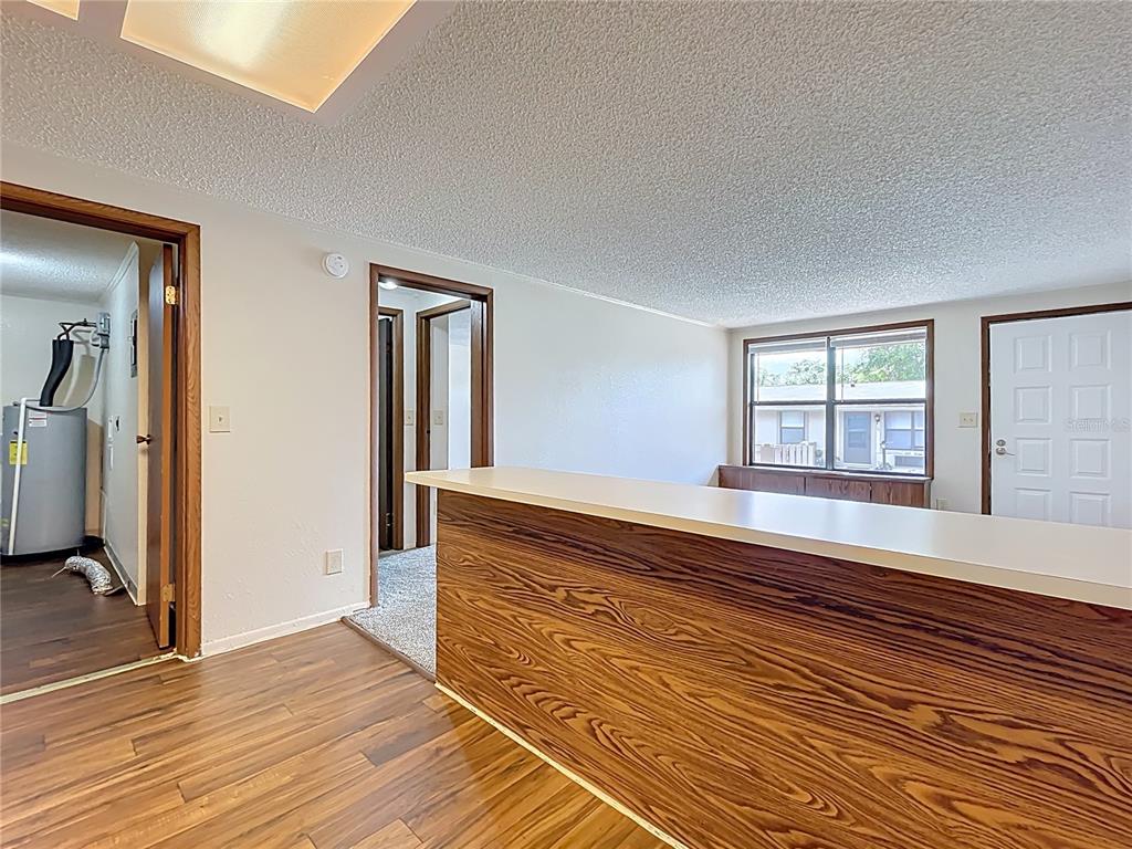 611 Mt Homer Road Eustis, FL 32726 - Photo 10 of 20 a view of an empty room with wooden floor and a window
