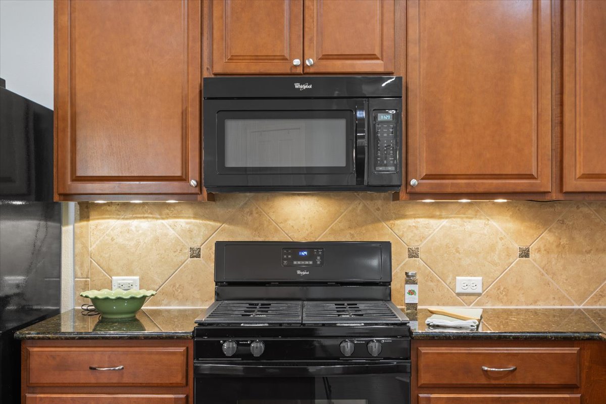 905 Mount Locke Court Georgetown, TX 78633 - Photo 11 of 36 a stove top oven sitting inside of a kitchen