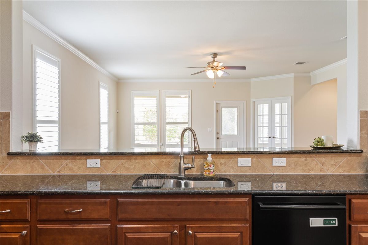 905 Mount Locke Court Georgetown, TX 78633 - Photo 12 of 36 a kitchen with granite countertop a sink a window stainless steel appliances and cabinets