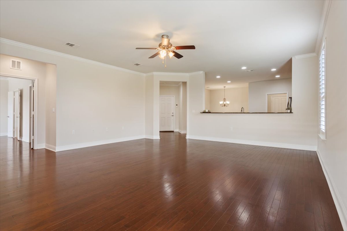 905 Mount Locke Court Georgetown, TX 78633 - Photo 15 of 36 an empty room with wooden floor and windows
