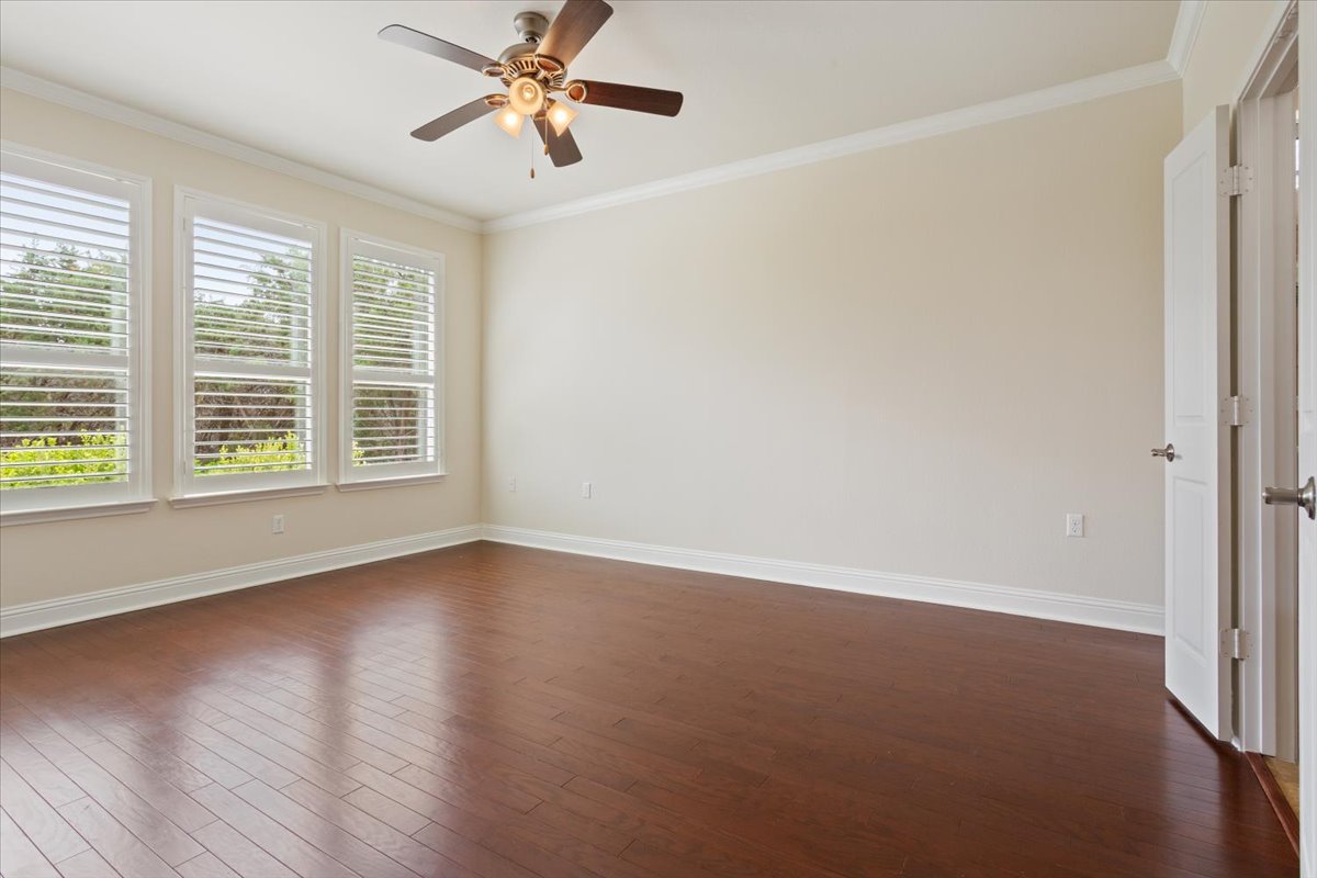 905 Mount Locke Court Georgetown, TX 78633 - Photo 19 of 36 an empty room with wooden floor and windows
