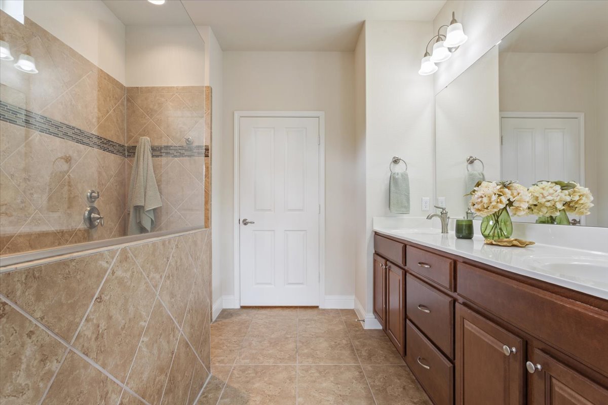 905 Mount Locke Court Georgetown, TX 78633 - Photo 22 of 36 a bathroom with a sink mirror and vanity