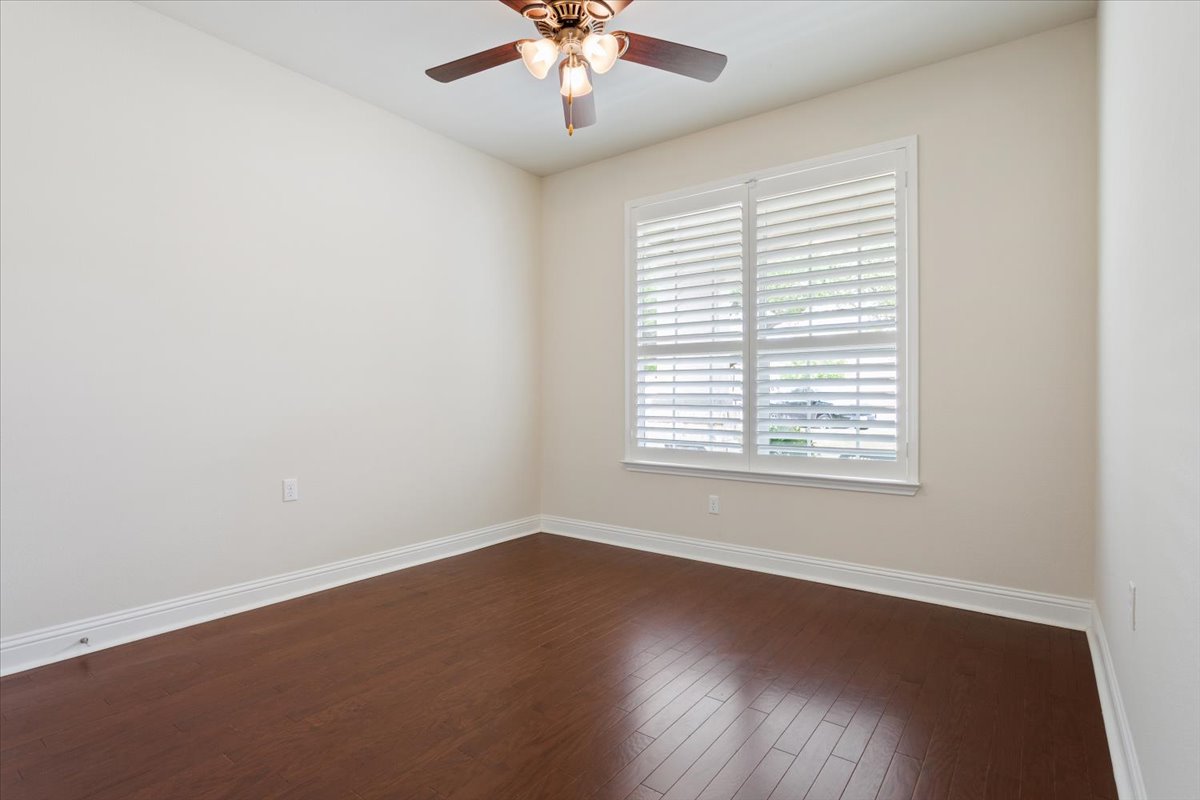 905 Mount Locke Court Georgetown, TX 78633 - Photo 26 of 36 an empty room with wooden floor and windows