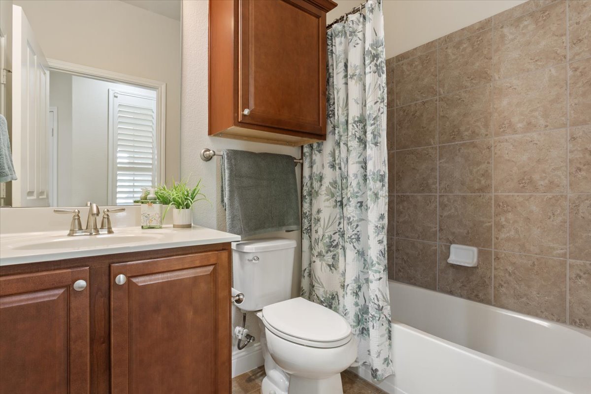 905 Mount Locke Court Georgetown, TX 78633 - Photo 27 of 36 a bathroom with a granite countertop toilet a sink and bathtub