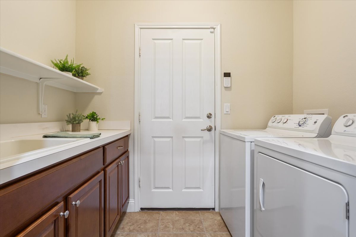 905 Mount Locke Court Georgetown, TX 78633 - Photo 28 of 36 a utility room with cabinets washer and dryer