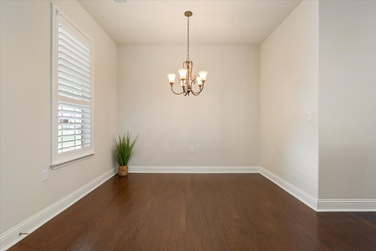 905 Mount Locke Court Georgetown, TX 78633 - Photo 8 of 36 an empty room with windows and chandelier