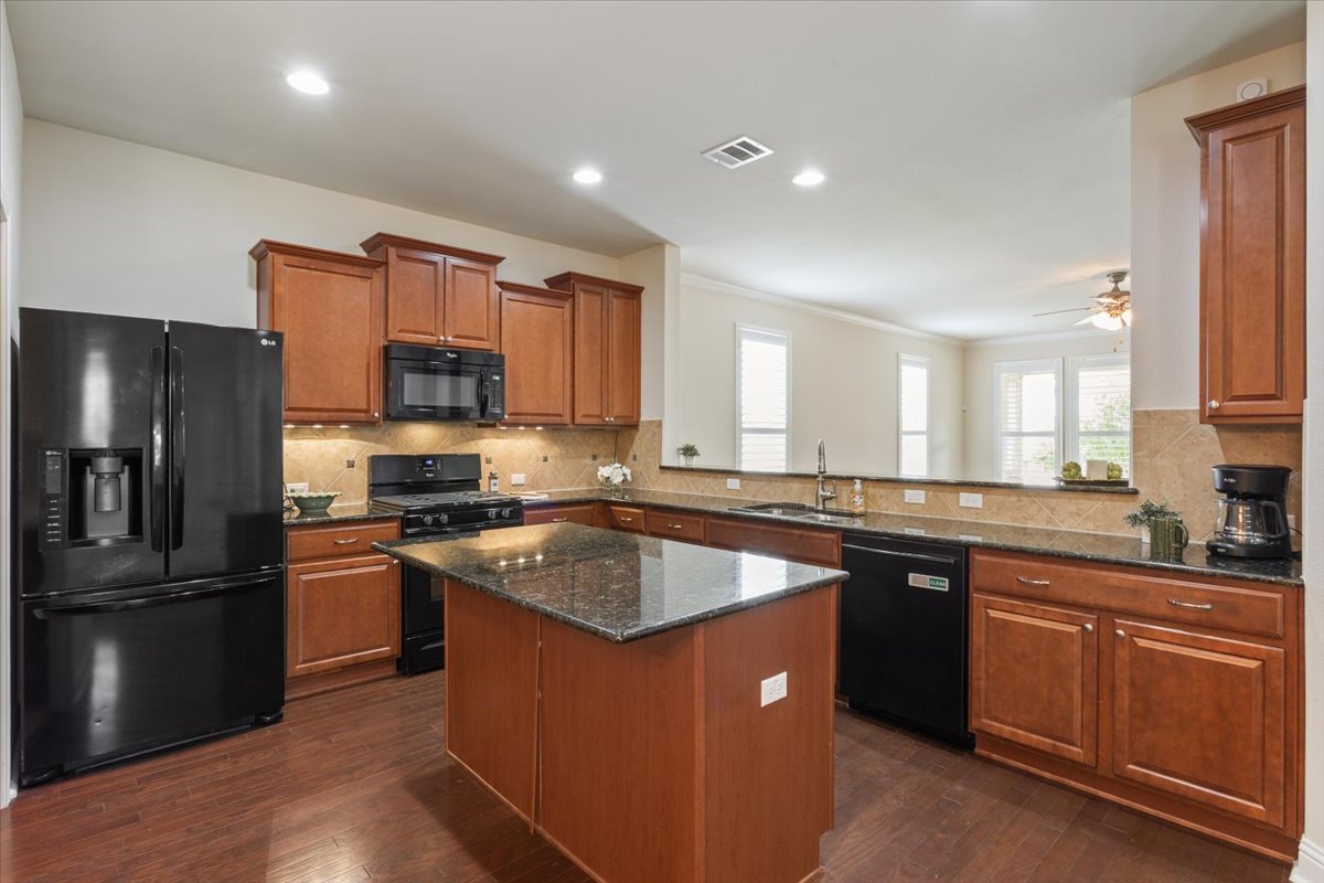 905 Mount Locke Court Georgetown, TX 78633 - Photo 9 of 36 a kitchen with stainless steel appliances granite countertop a stove a sink dishwasher a refrigerator and a microwave