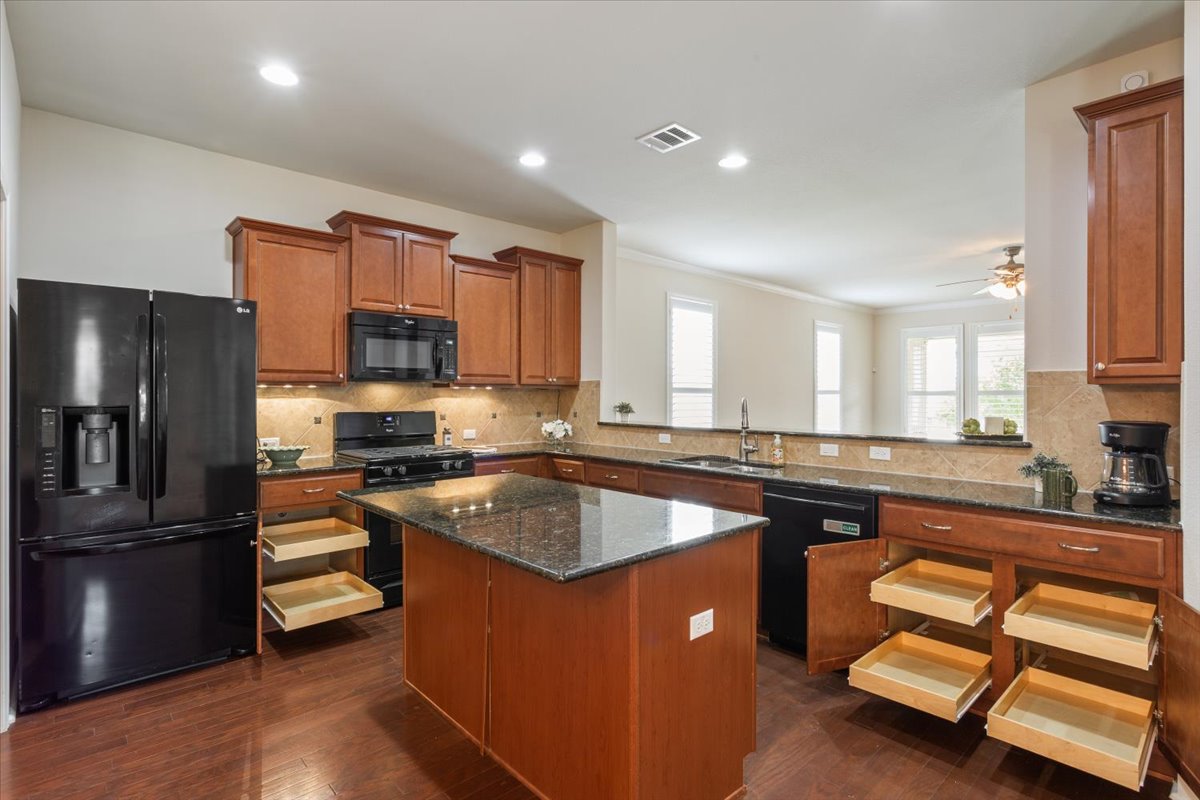 905 Mount Locke Court Georgetown, TX 78633 - Photo 10 of 36 a kitchen with a sink stove and refrigerator