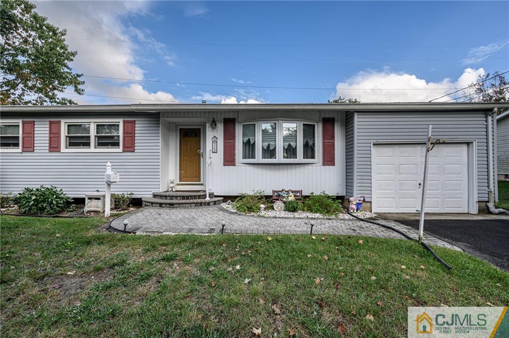 25 Drexel Drive Jackson, NJ 08527 - Photo 1 of 34 a front view of a house with a yard and garage