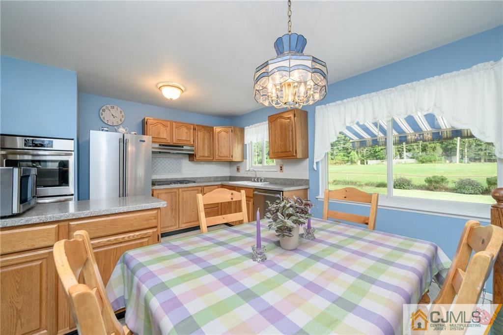 25 Drexel Drive Jackson, NJ 08527 - Photo 12 of 34 a kitchen with stainless steel appliances granite countertop a sink and a stove