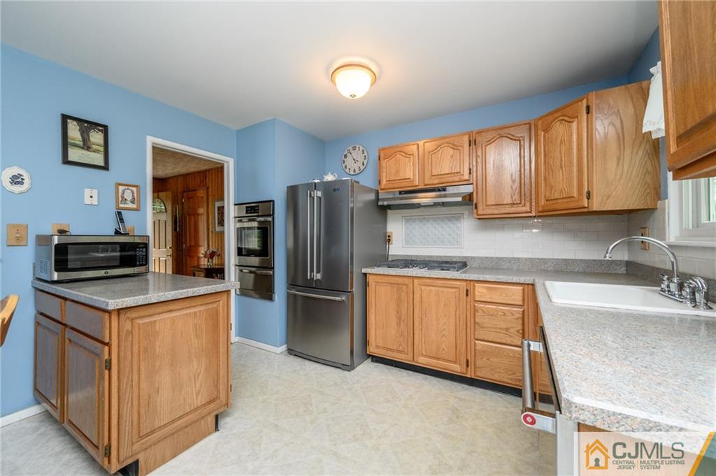 25 Drexel Drive Jackson, NJ 08527 - Photo 14 of 34 a kitchen with stainless steel appliances granite countertop a refrigerator stove and sink