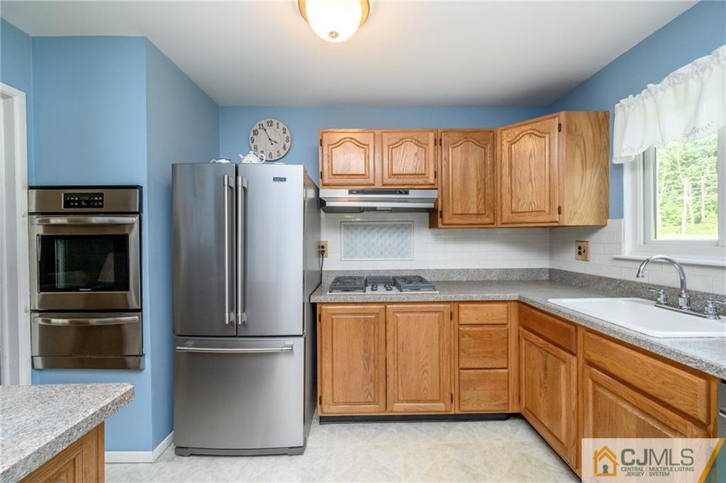 25 Drexel Drive Jackson, NJ 08527 - Photo 16 of 34 a kitchen with stainless steel appliances granite countertop a refrigerator and a sink