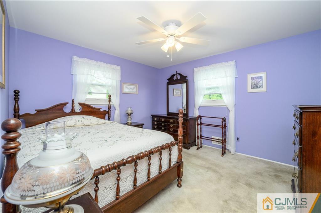 25 Drexel Drive Jackson, NJ 08527 - Photo 20 of 34 a bed room with a bed and a chandelier