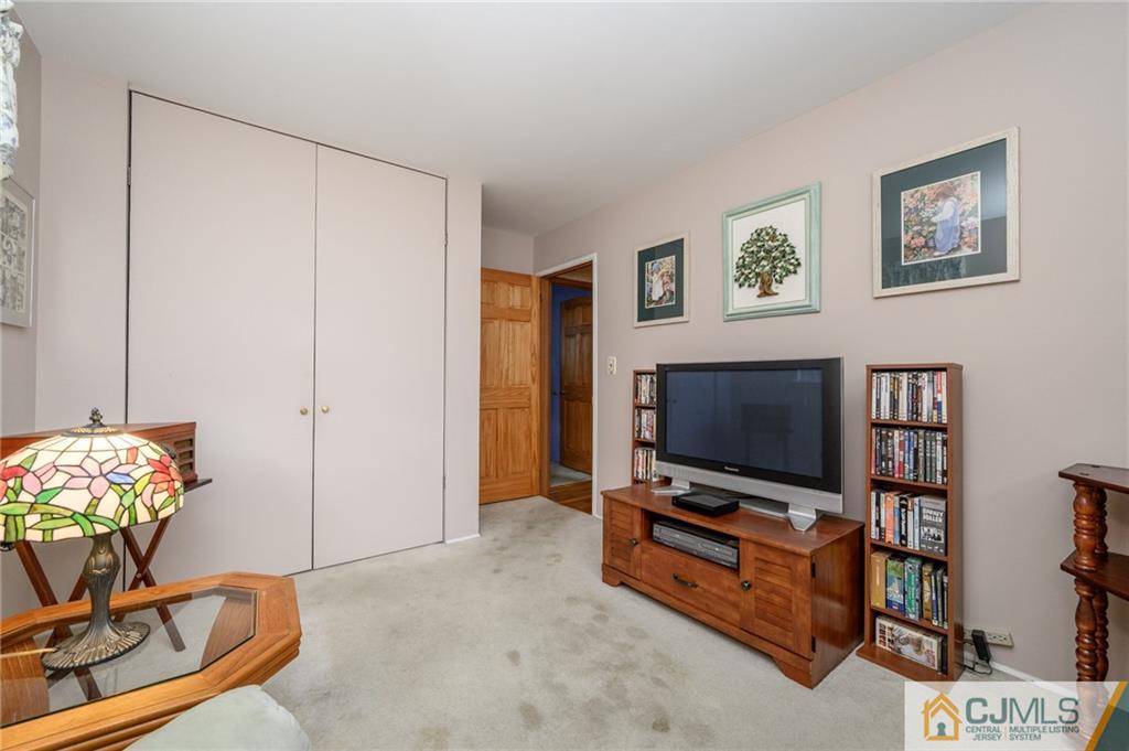 25 Drexel Drive Jackson, NJ 08527 - Photo 25 of 34 a living room with furniture and a flat screen tv