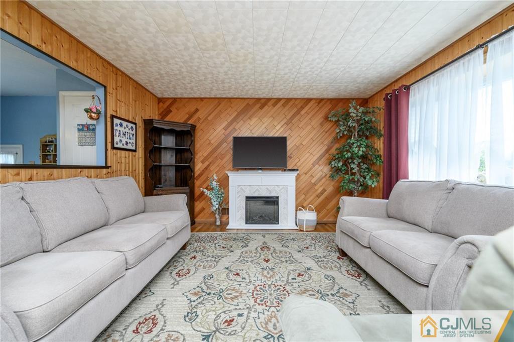 25 Drexel Drive Jackson, NJ 08527 - Photo 5 of 34 a living room with furniture a fireplace and a flat screen tv