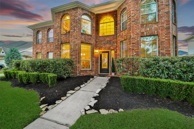 a view of a brick building next to a yard