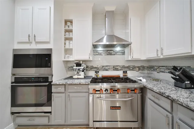 a kitchen with granite countertop a stove and a sink