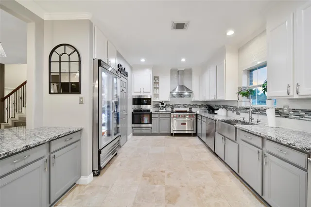 a kitchen with granite countertop stainless steel appliances and white cabinets