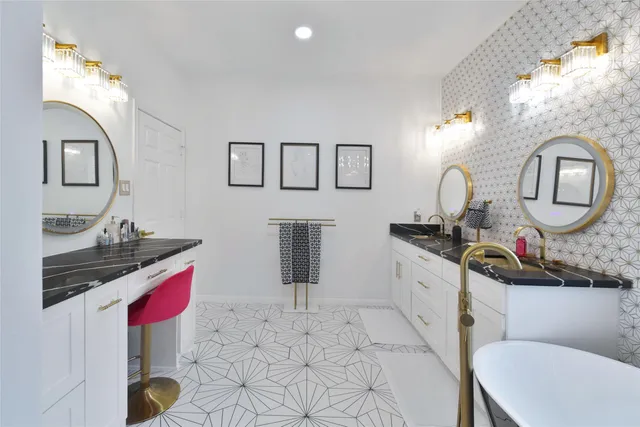 a bathroom with a sink vanity and mirror