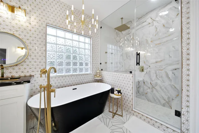 a bathroom with a sink a toilet a mirror and shower