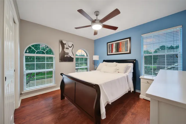 a bed sitting in a bedroom next to a window