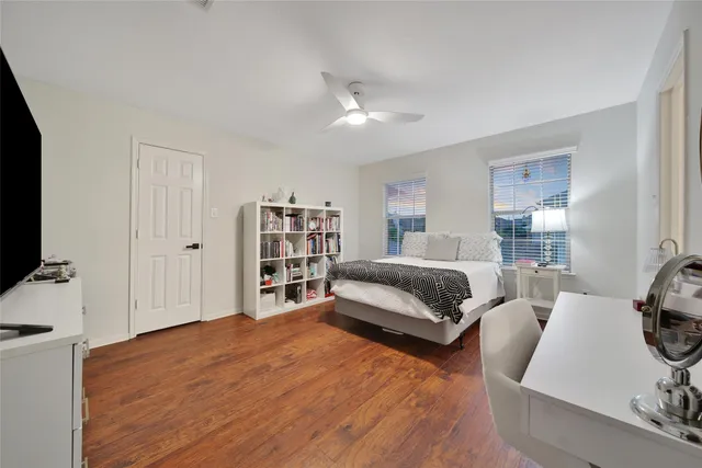 a bedroom with furniture and a flat screen tv