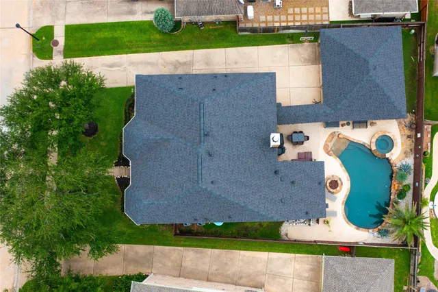 an aerial view of residential house with outdoor space and parking