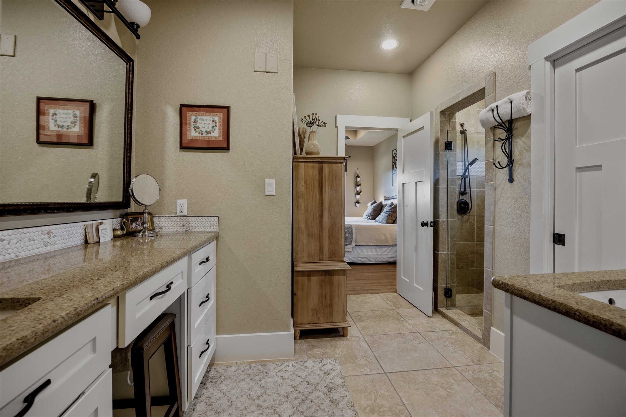 261 Barber Drive Wimberley, TX 78676 - Photo 21 of 37 Ensuite bathroom featuring vanity, a stall shower, and light tile patterned floors
