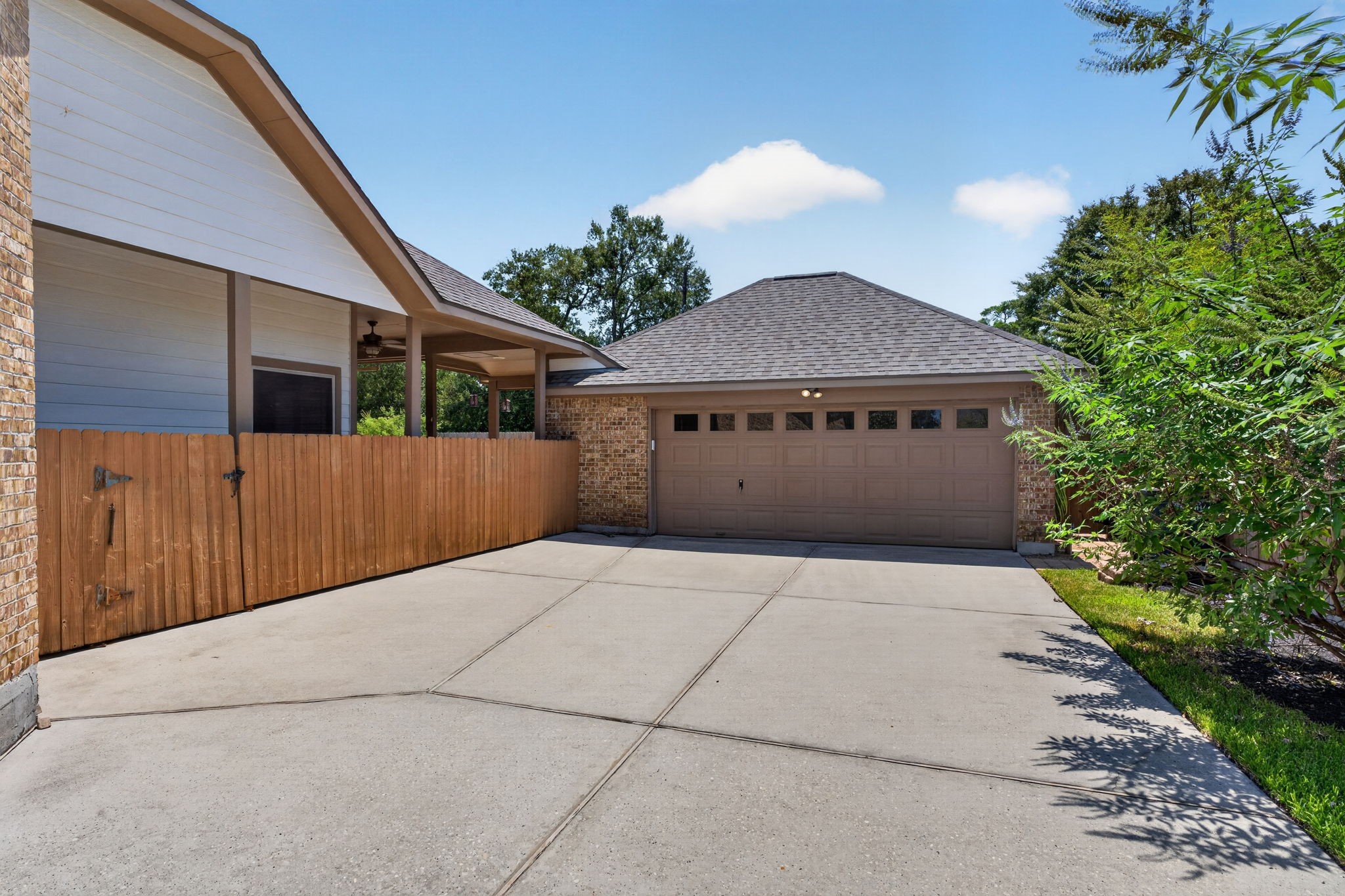 Extended driveway leads to the oversized detached garage, providing generous parking and additional storage possibilities.