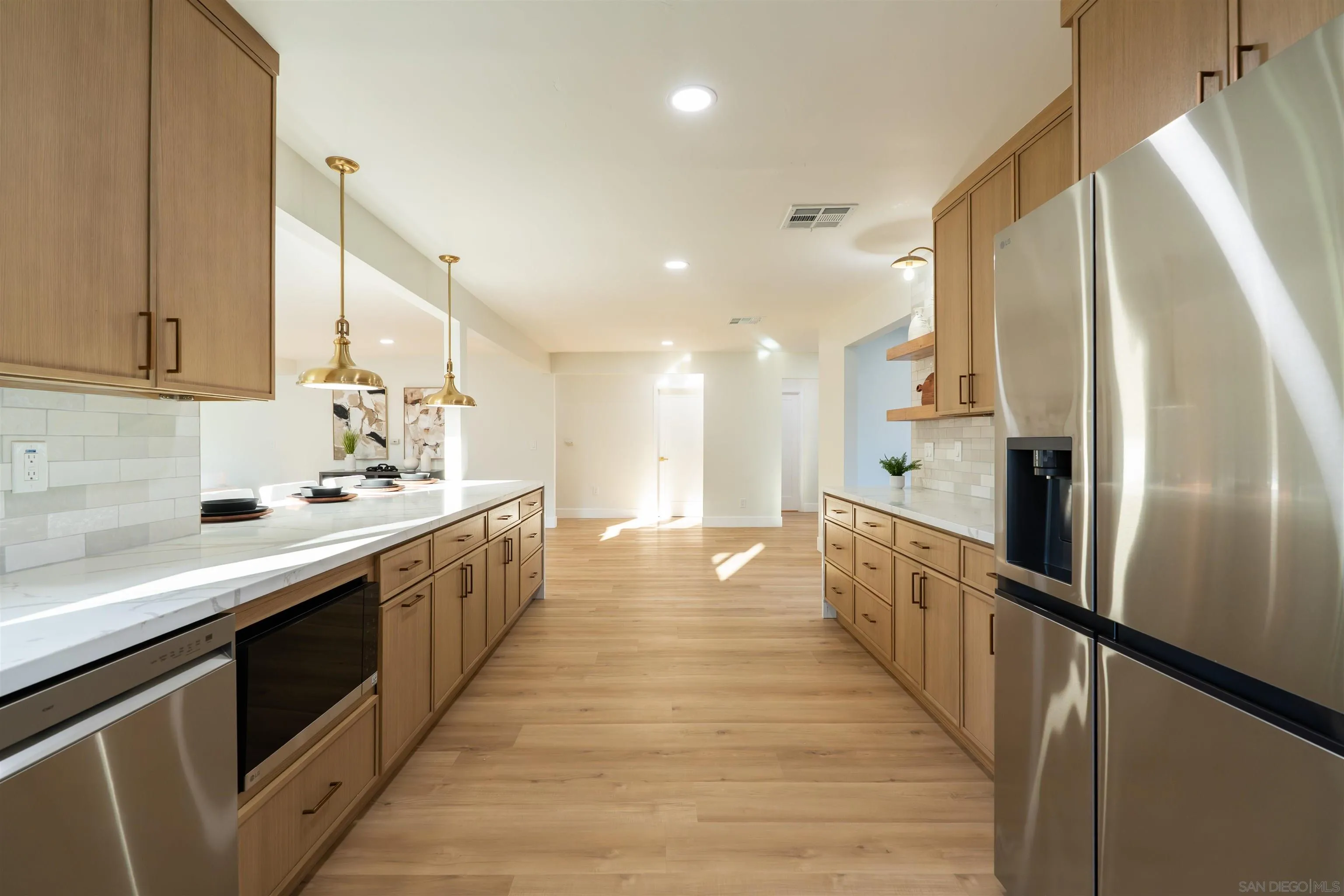 4112 Lois Street La Mesa, CA 91941 - Photo 11 of 39 a large kitchen with stainless steel appliances a sink and cabinets
