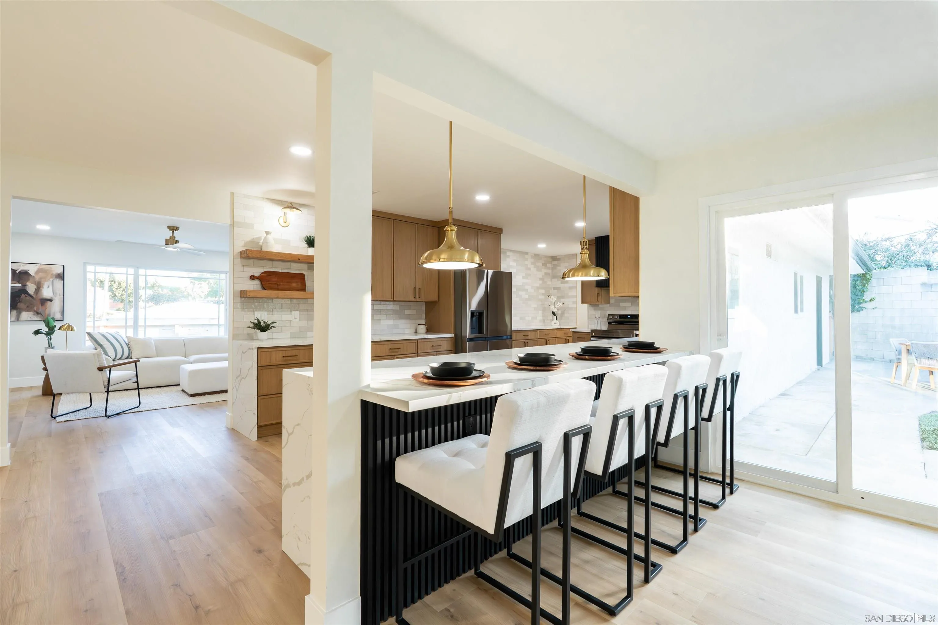 4112 Lois Street La Mesa, CA 91941 - Photo 13 of 39 a kitchen with stainless steel appliances kitchen island granite countertop a table chairs sink and cabinets