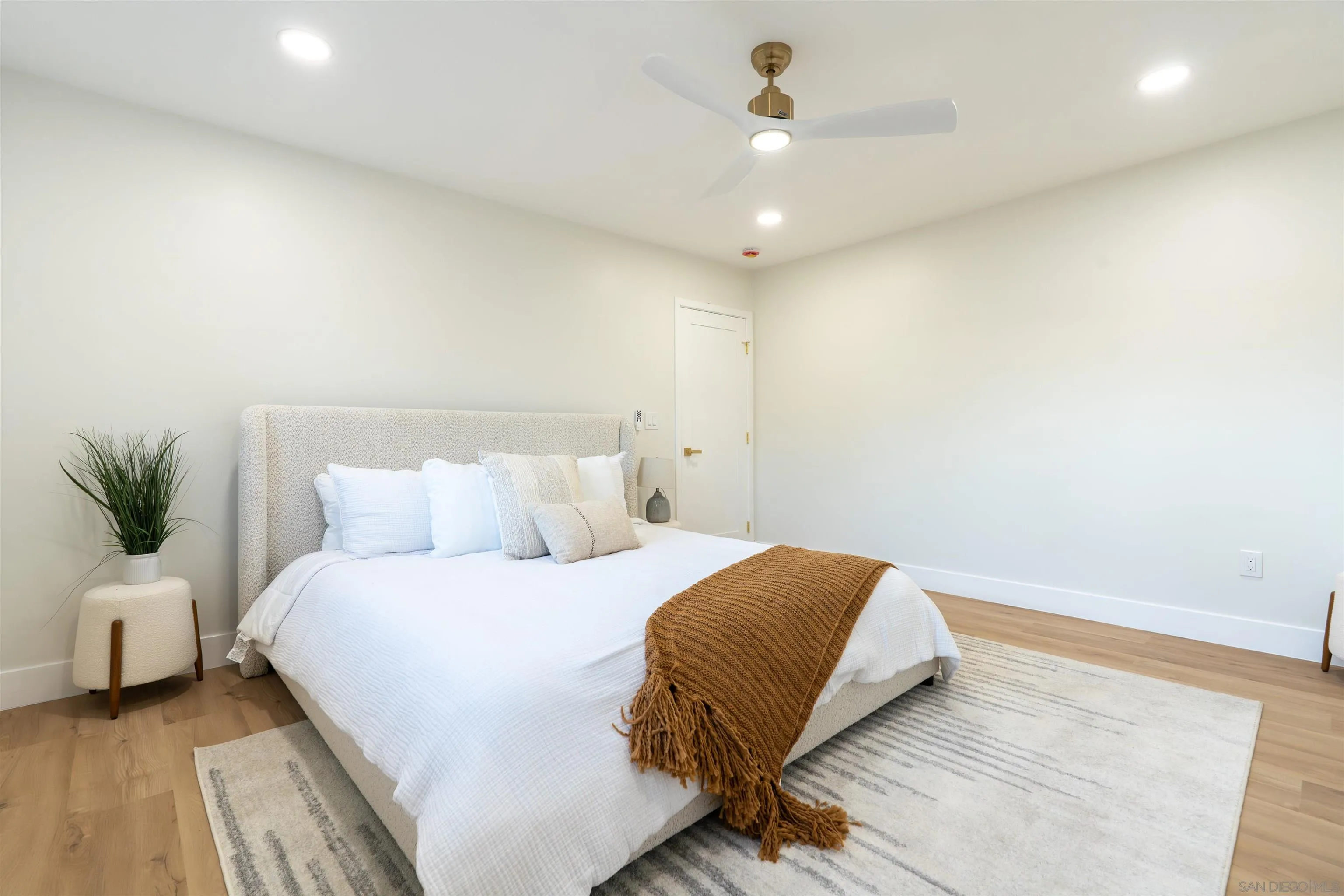 4112 Lois Street La Mesa, CA 91941 - Photo 22 of 39 a bedroom with a bed and a potted plant