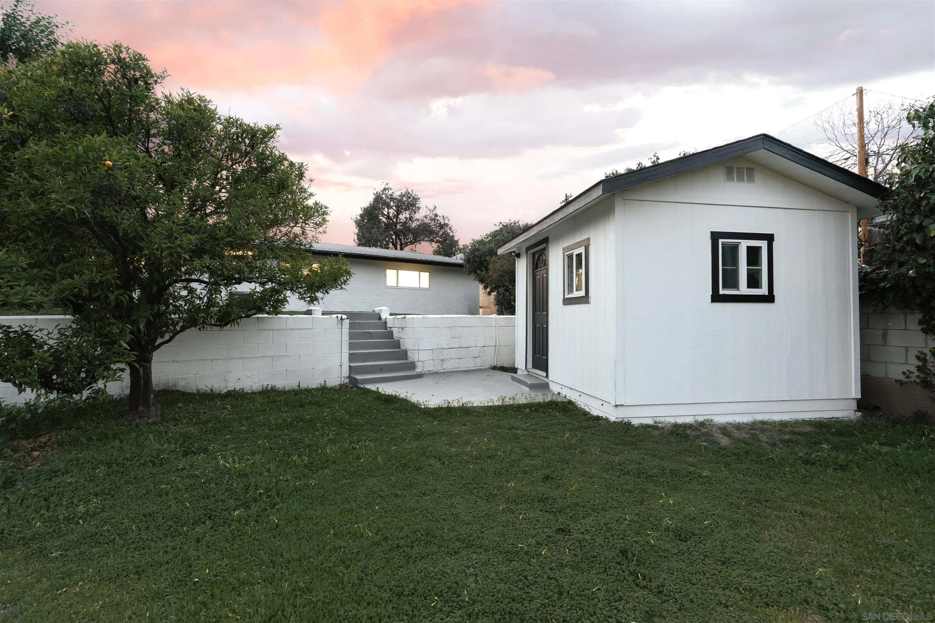 4112 Lois Street La Mesa, CA 91941 - Photo 36 of 39 a white house that has a small yard and a trees