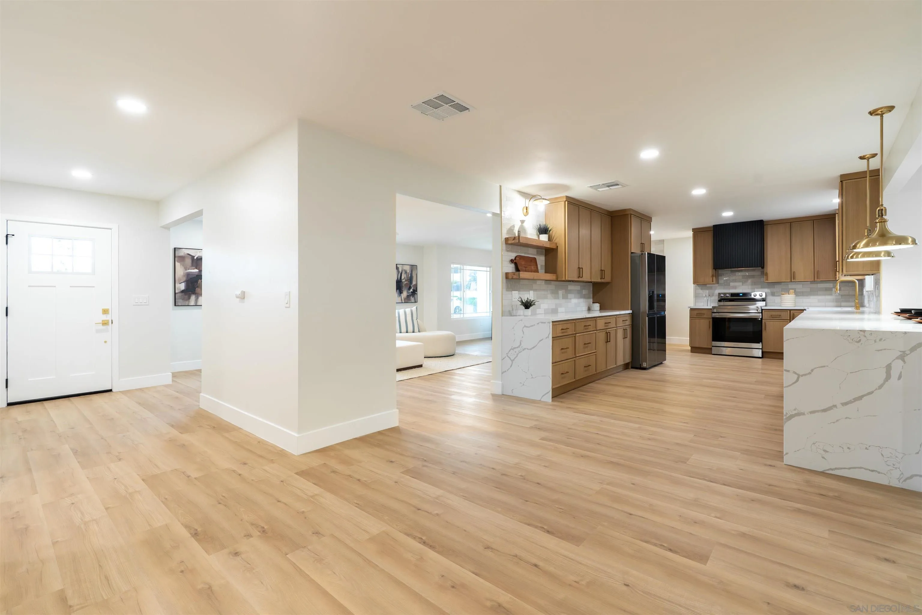 4112 Lois Street La Mesa, CA 91941 - Photo 5 of 39 a view of kitchen with kitchen island a sink wooden floor and stainless steel appliances