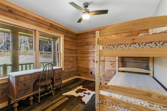 a view of a bedroom with wooden floor