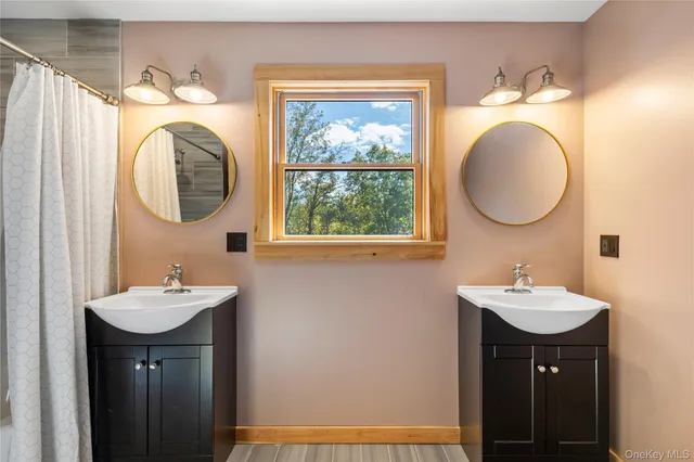 a view of a house with a big yard and large trees