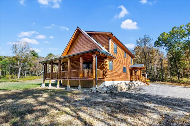 a view of a house with swimming pool and sitting area