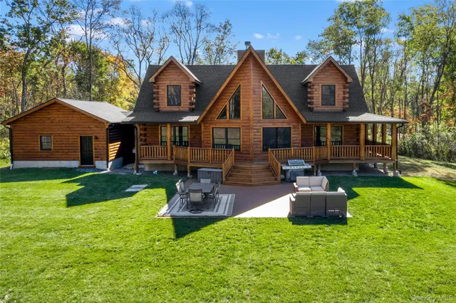 a front view of house with yard and outdoor seating