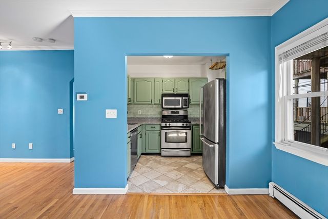 a kitchen with a refrigerator and a stove top oven