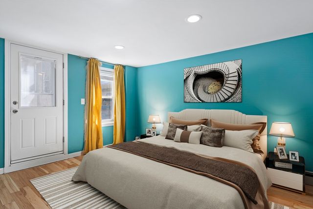 a bedroom with a bed and painting on the wall