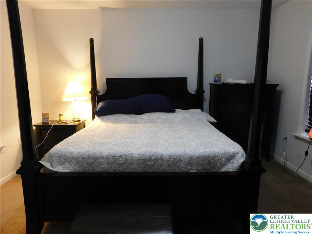 1047 Cetronia Road, Unit 3 Breinigsville, PA 18031 - Photo 11 of 19 a large bed sitting in a bedroom next to a window