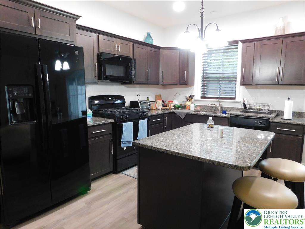 1047 Cetronia Road, Unit 3 Breinigsville, PA 18031 - Photo 6 of 19 a kitchen with stainless steel appliances granite countertop a sink a stove and a refrigerator